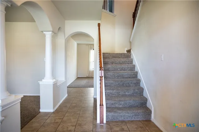 a view of a livingroom with stairs