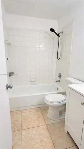 a bathroom with a toilet a sink and shower
