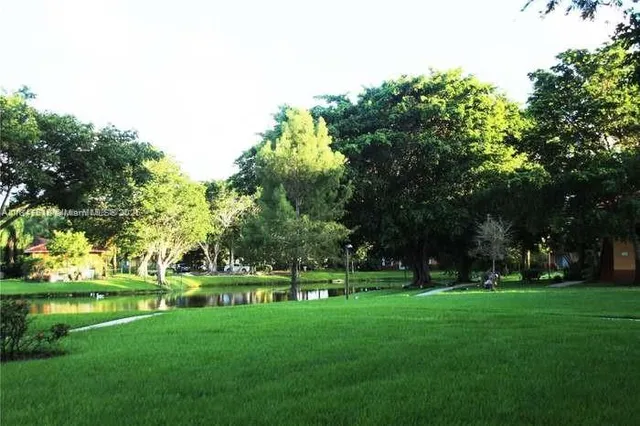 a green field with lots of trees