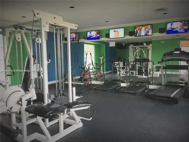 a room with gym equipment and a large window