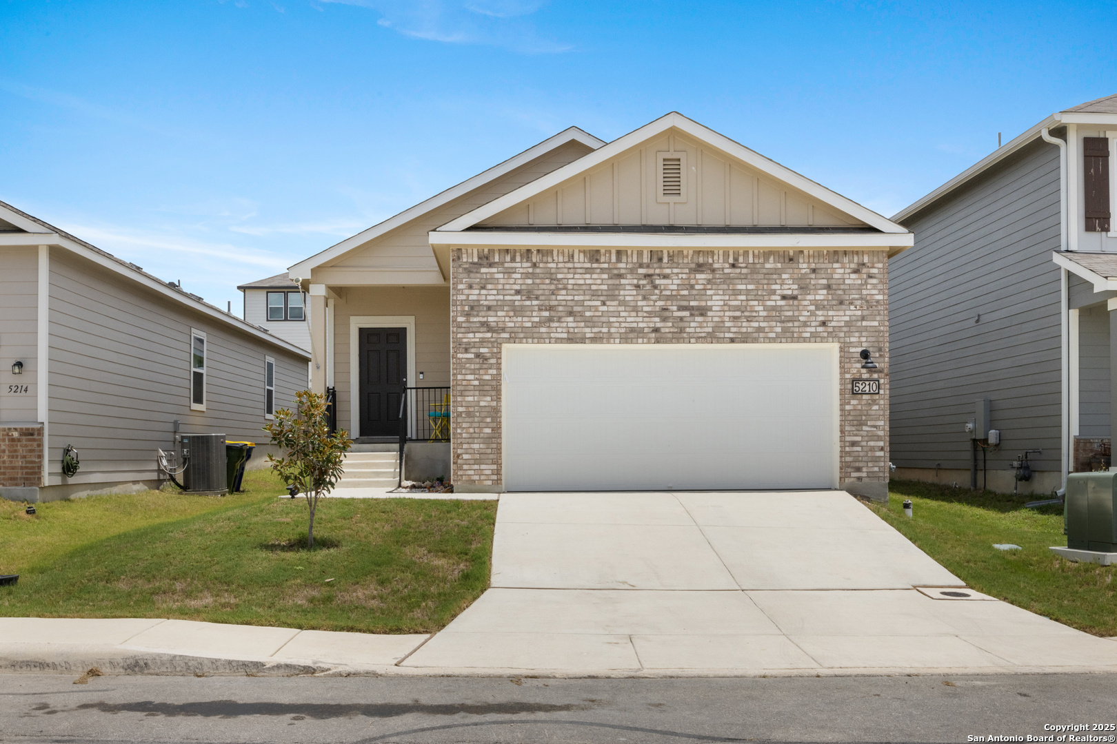 a front view of a house with a yard and garage