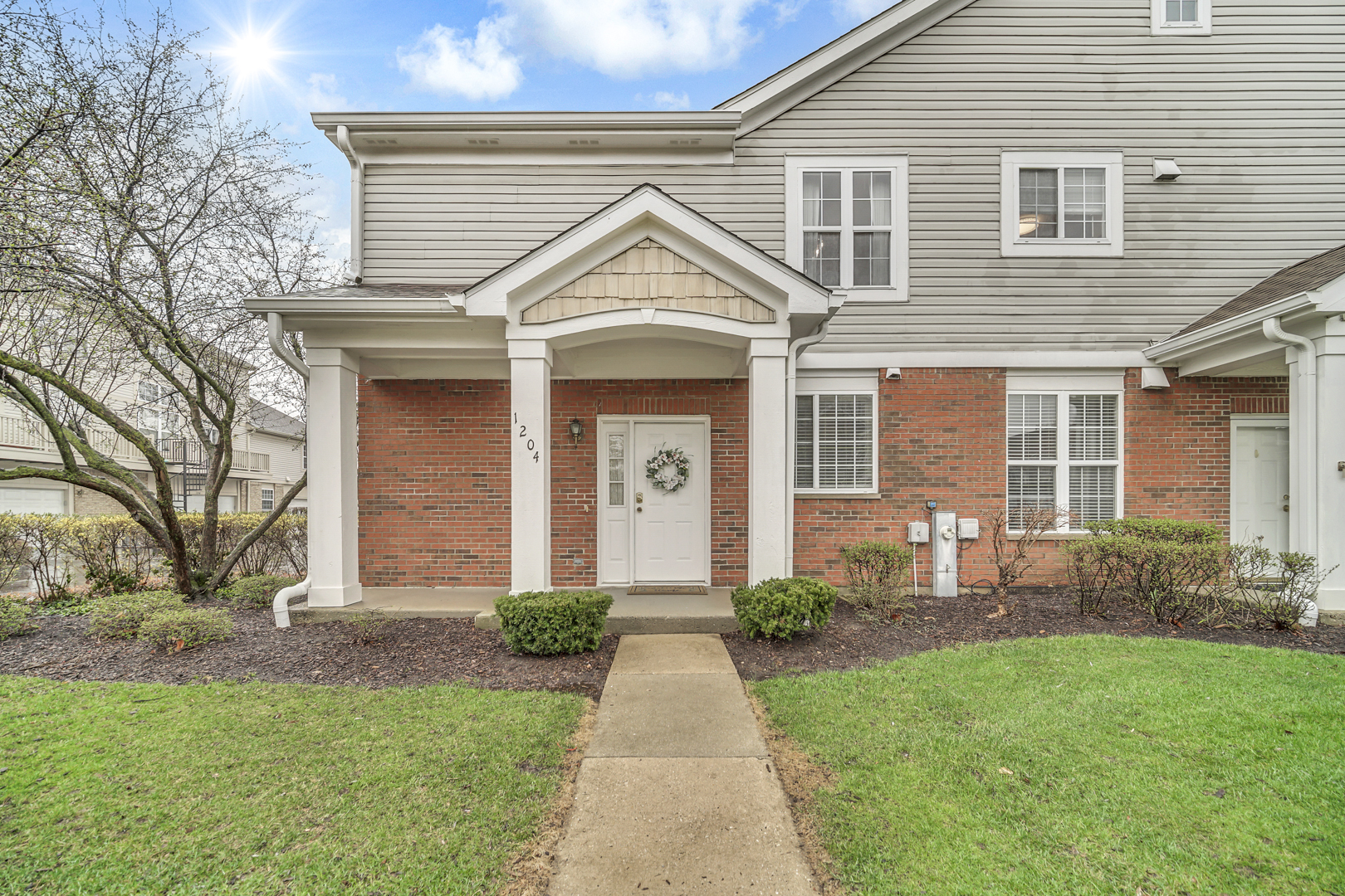 1204 Georgetown Way Vernon Hills, IL 60061 - Photo 1 of 30 a front view of a house with garden