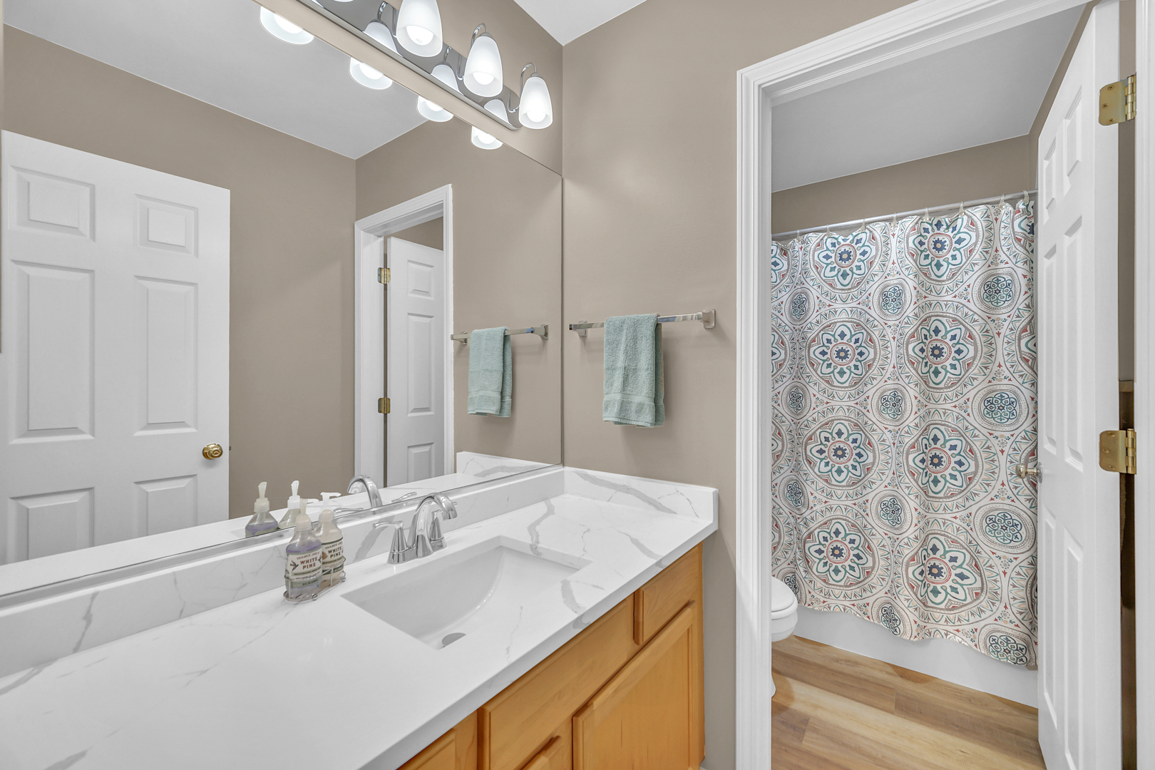 1204 Georgetown Way Vernon Hills, IL 60061 - Photo 22 of 30 a bathroom with double vanity sinks a vanity two mirror and shower