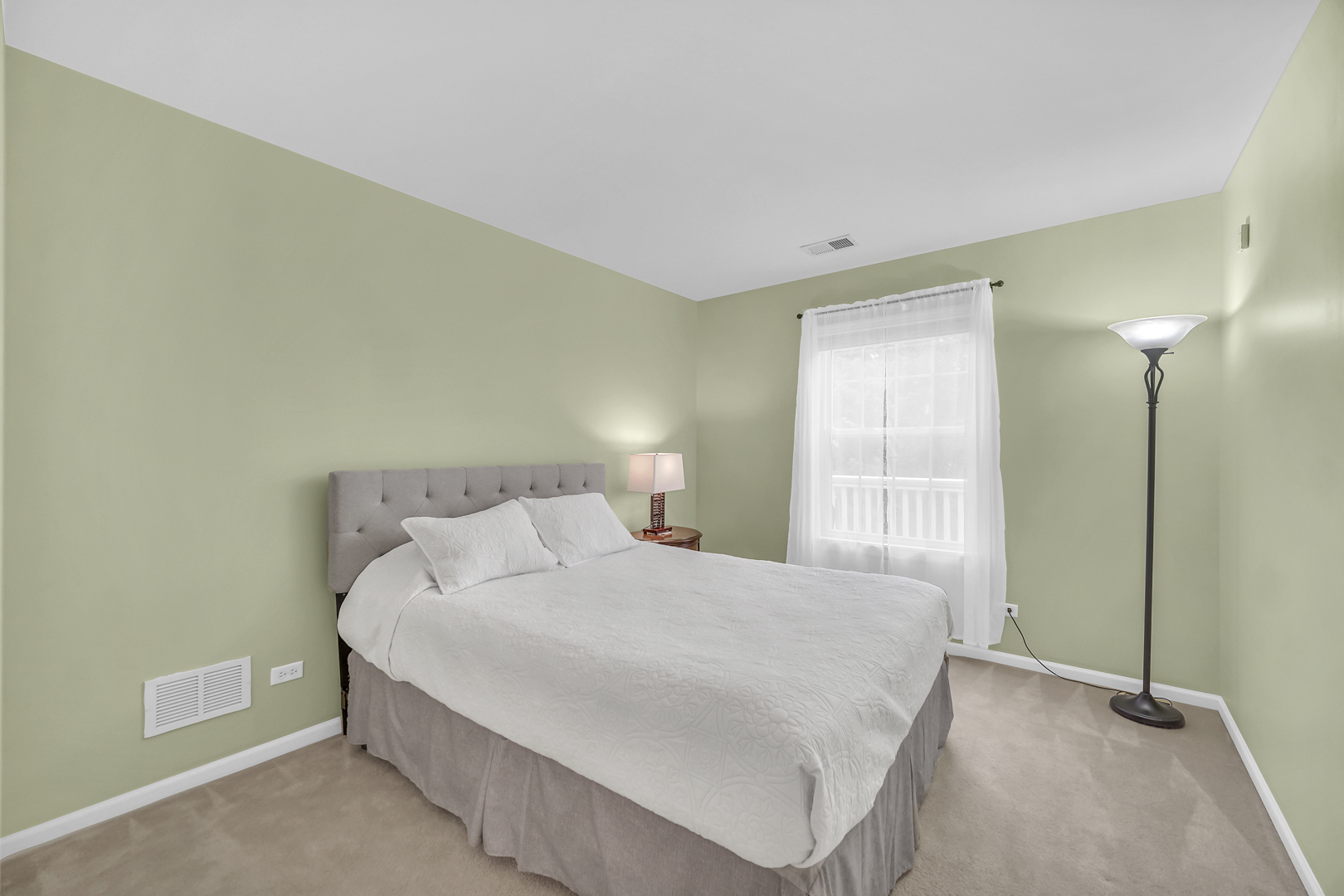 1204 Georgetown Way Vernon Hills, IL 60061 - Photo 24 of 30 a bedroom with a bed and a lamp