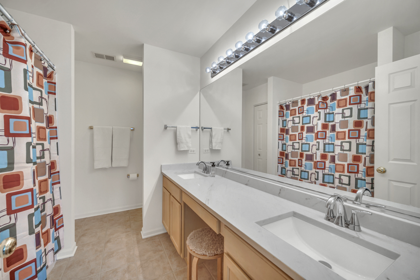 1204 Georgetown Way Vernon Hills, IL 60061 - Photo 26 of 30 a bathroom with a sink a large mirror and a shower
