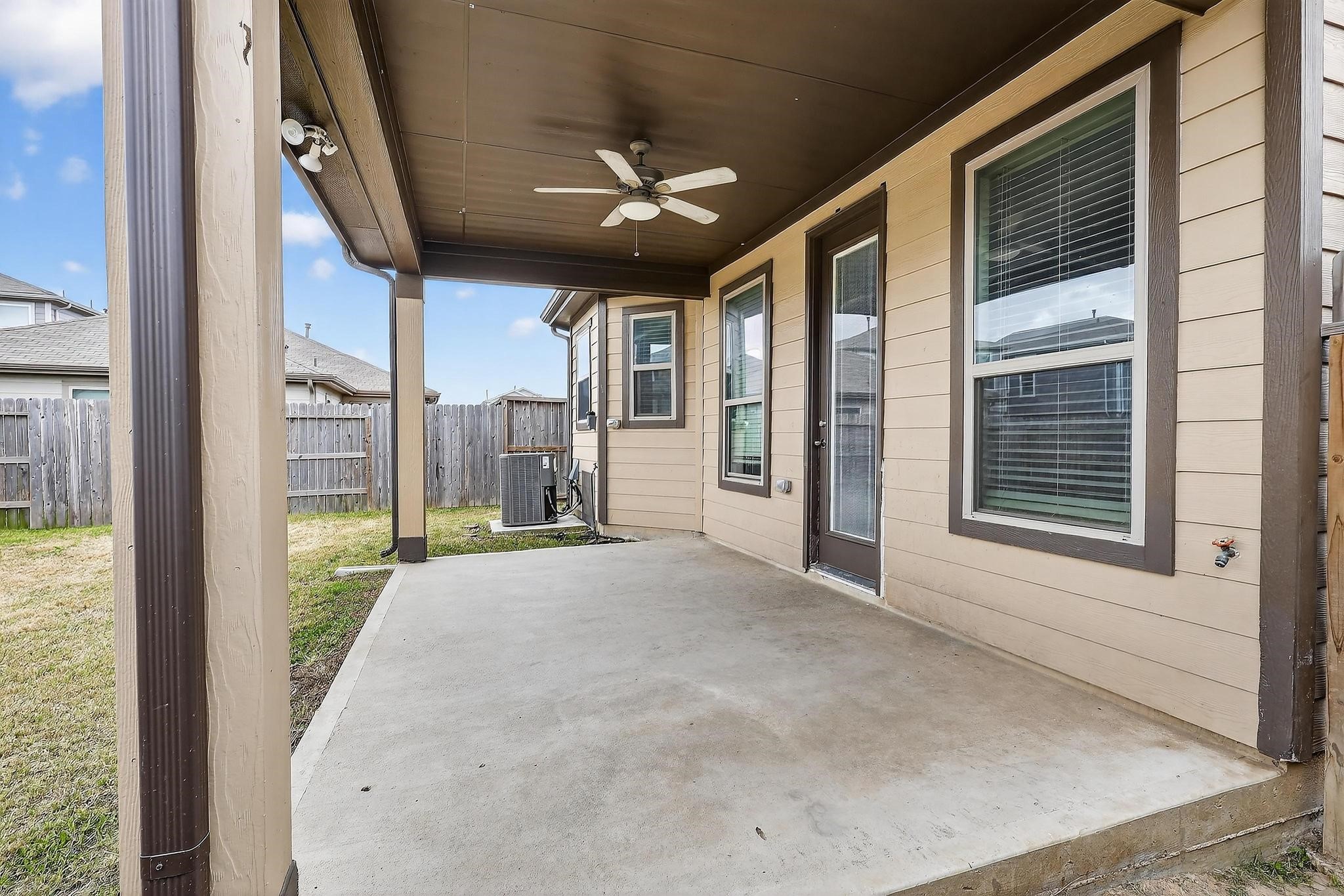 3322 Nila Creek Dr Spring Spring, TX 77373 - Photo 31 of 36 Covered backyard patio with ceiling fan, perfect for outdoor seating and relaxing while overlooking the fenced yard.