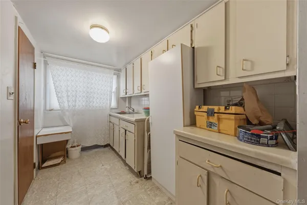 a kitchen with cabinets and appliances