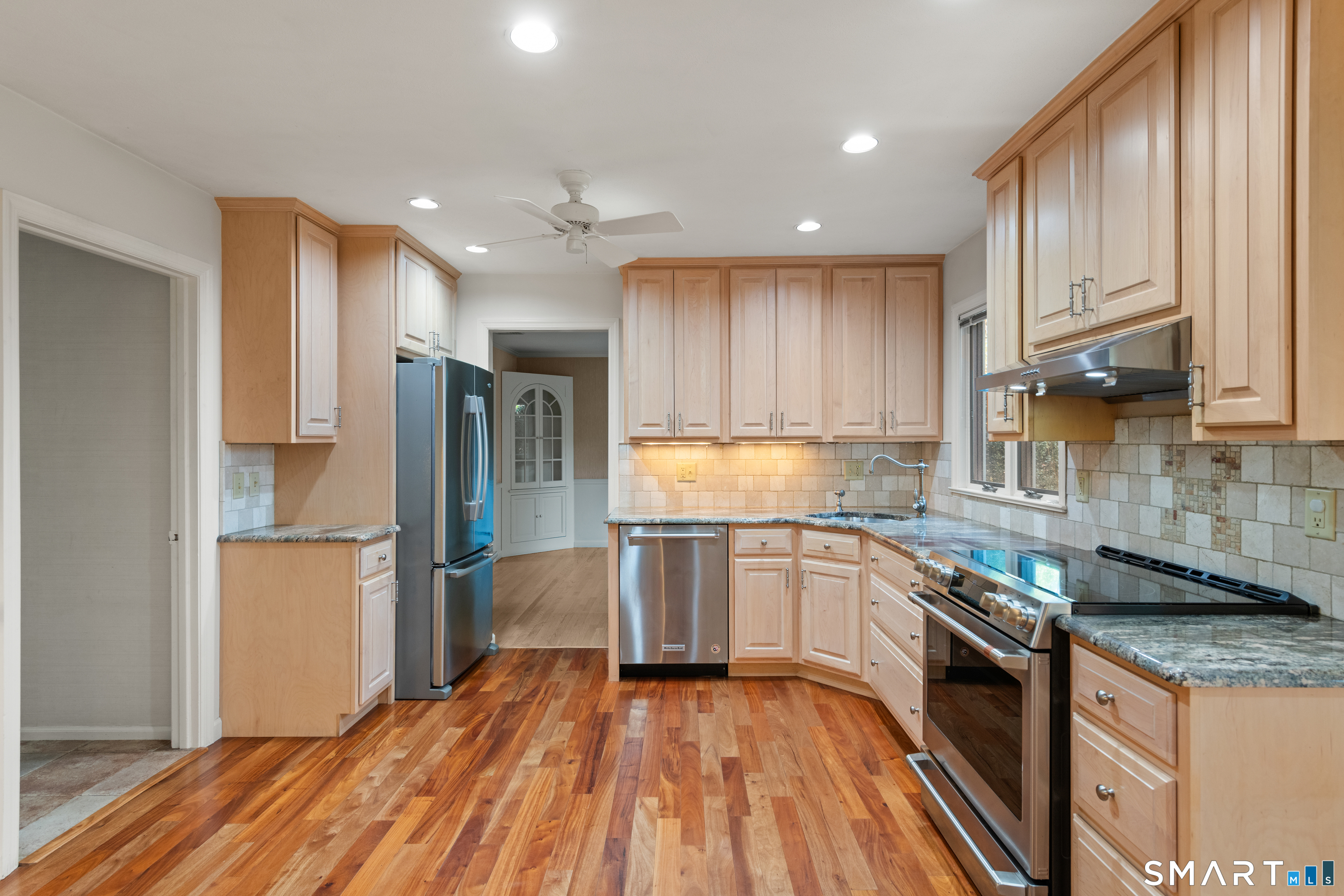 56 Drake Lane Fairfield, CT 06824 - Photo 11 of 35 a kitchen with granite countertop stainless steel appliances and wooden cabinets