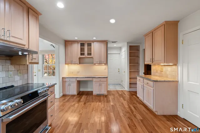 a kitchen with granite countertop a stove and a refrigerator