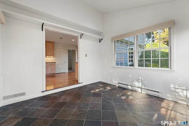 an empty room with windows and entrance