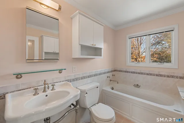 a white bath tub sitting next to a white sink