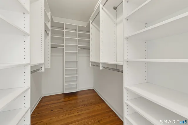 a view of walk in closet with empty racks