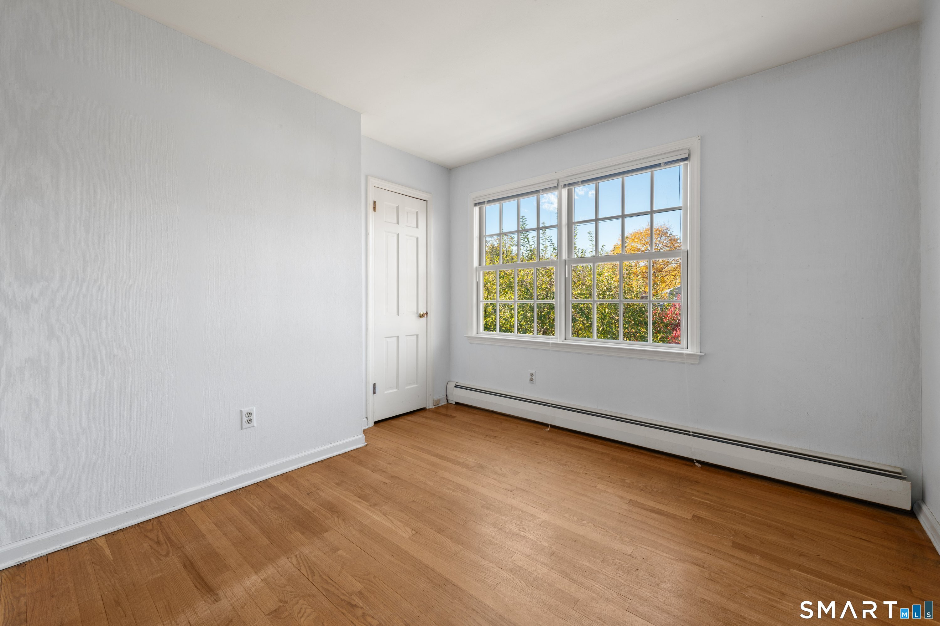 56 Drake Lane Fairfield, CT 06824 - Photo 27 of 35 an empty room with wooden floor and windows