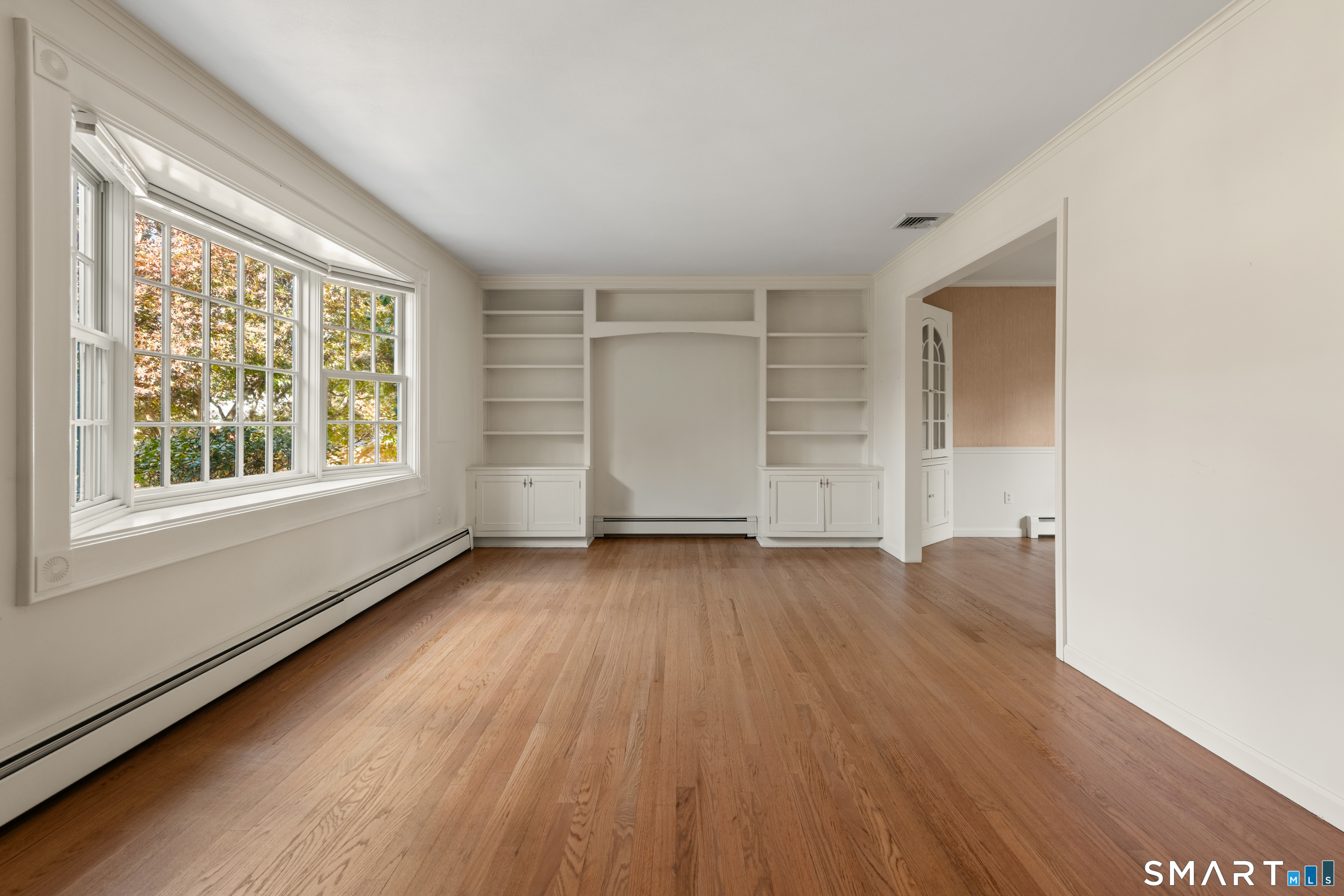 56 Drake Lane Fairfield, CT 06824 - Photo 6 of 35 an empty room with wooden floor and windows