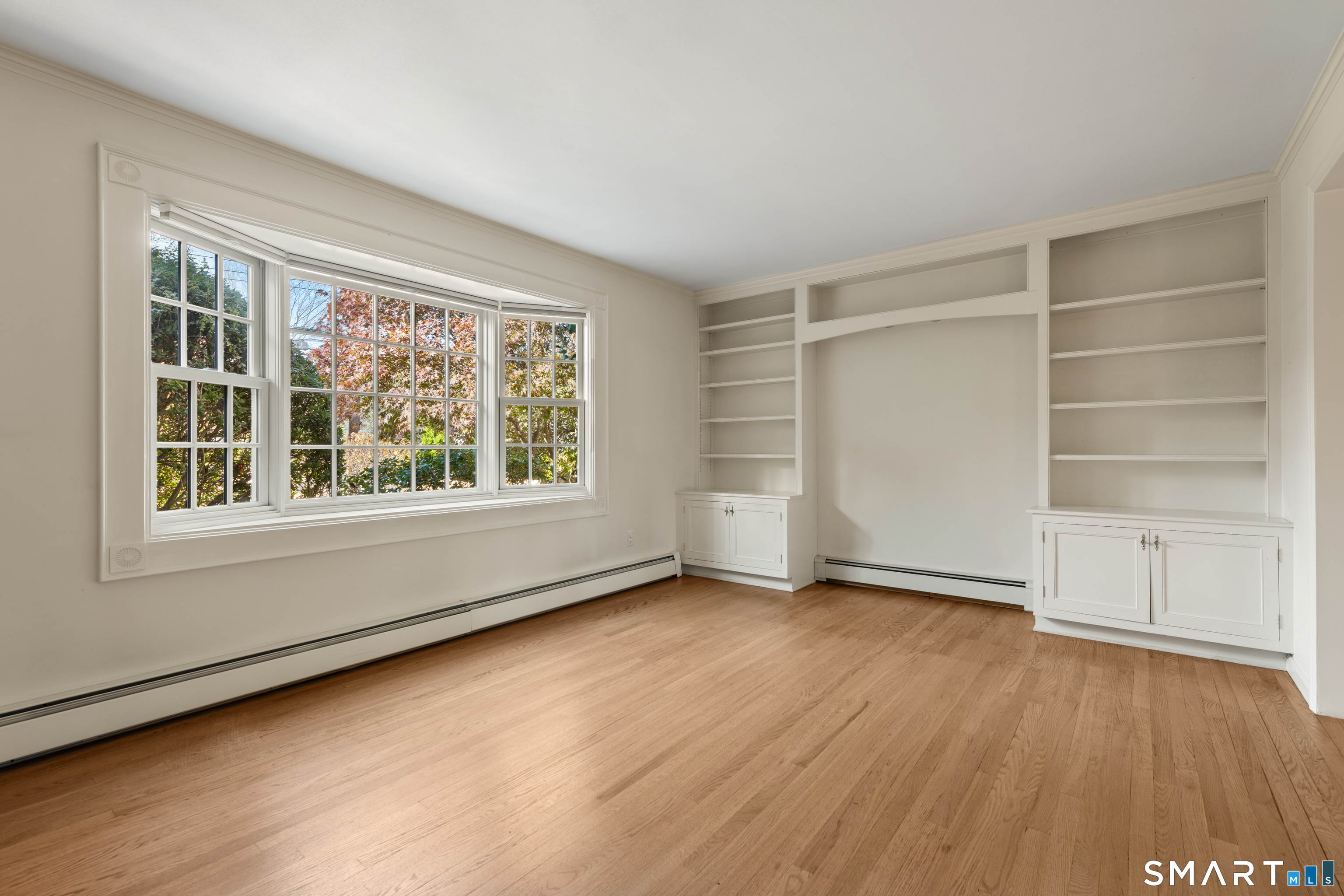 56 Drake Lane Fairfield, CT 06824 - Photo 7 of 35 an empty room with wooden floor and window