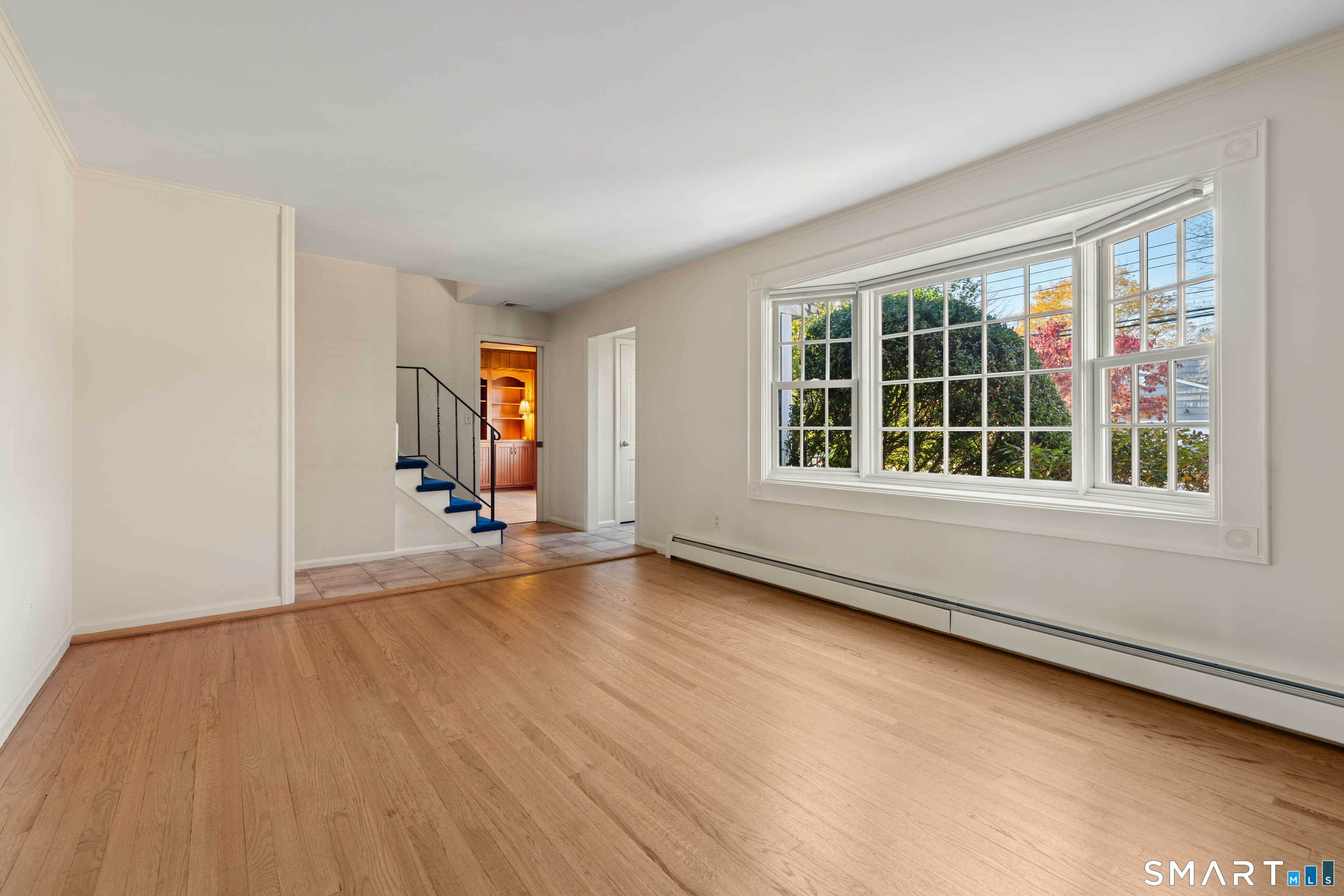 56 Drake Lane Fairfield, CT 06824 - Photo 8 of 35 a view of an empty room with wooden floor and a window