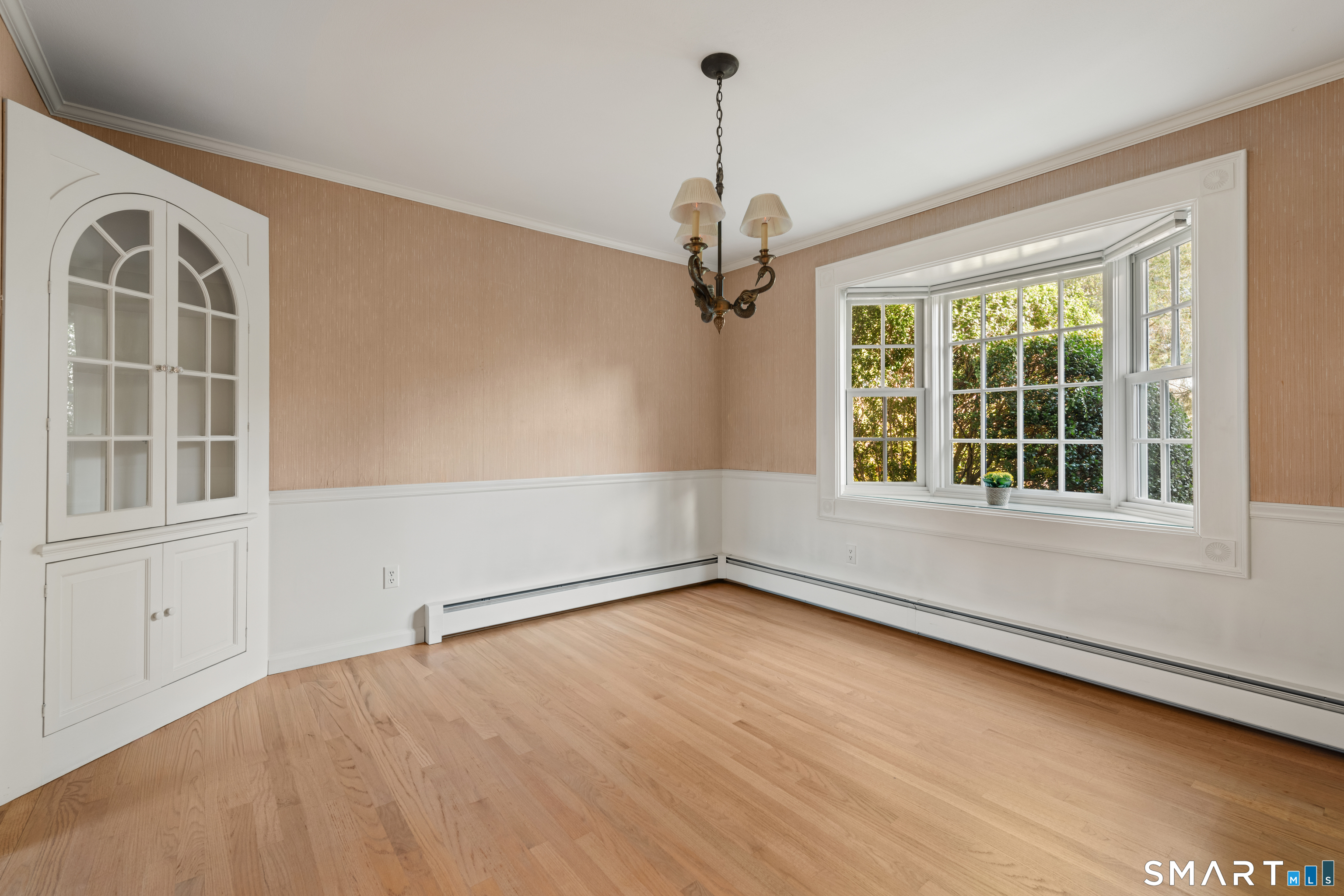 56 Drake Lane Fairfield, CT 06824 - Photo 9 of 35 a view of an empty room with a window and wooden floor
