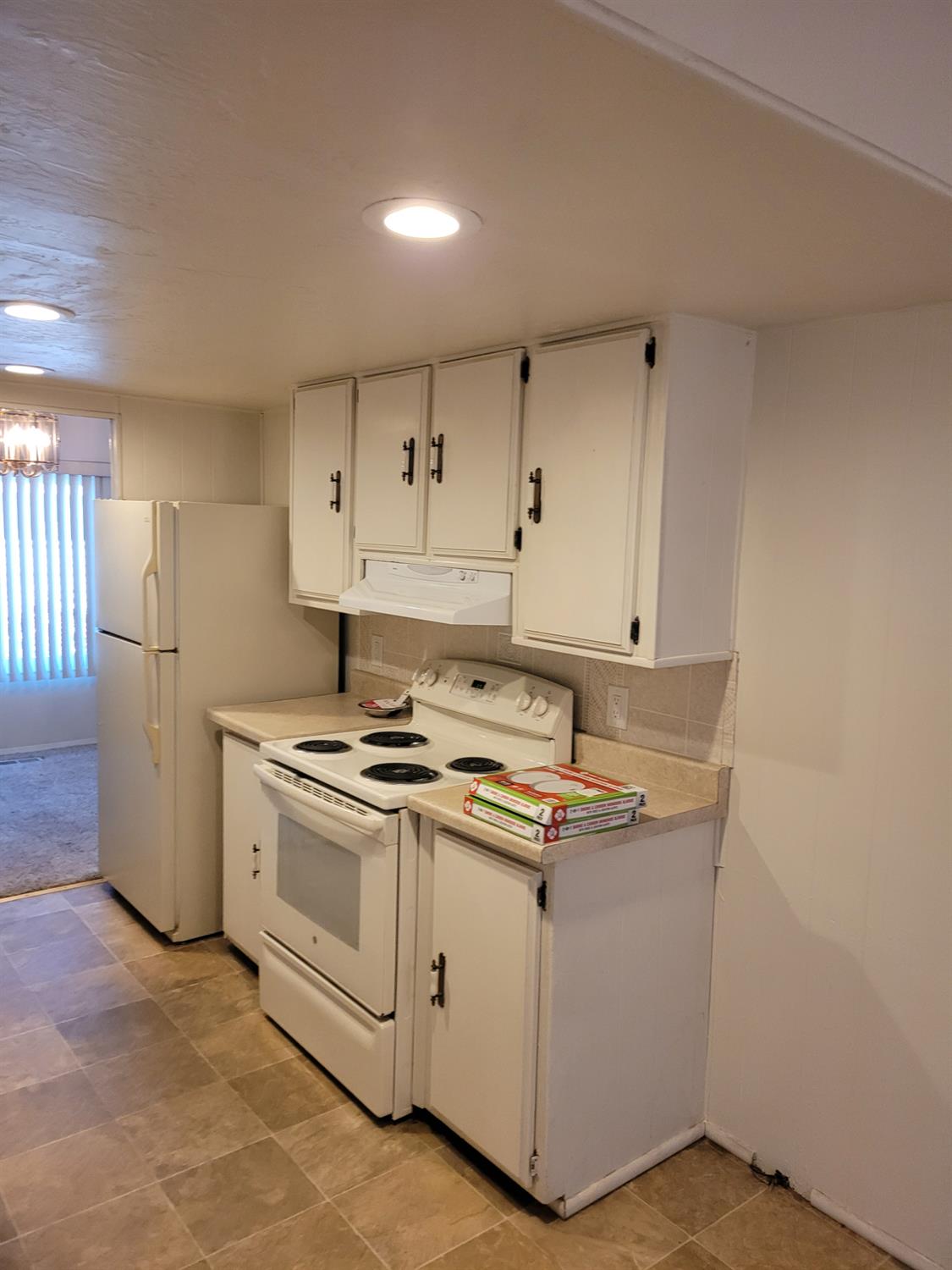 3955 Coffee Road, Unit 53 Modesto, CA 95355 - Photo 13 of 26 a kitchen with a stove and a refrigerator