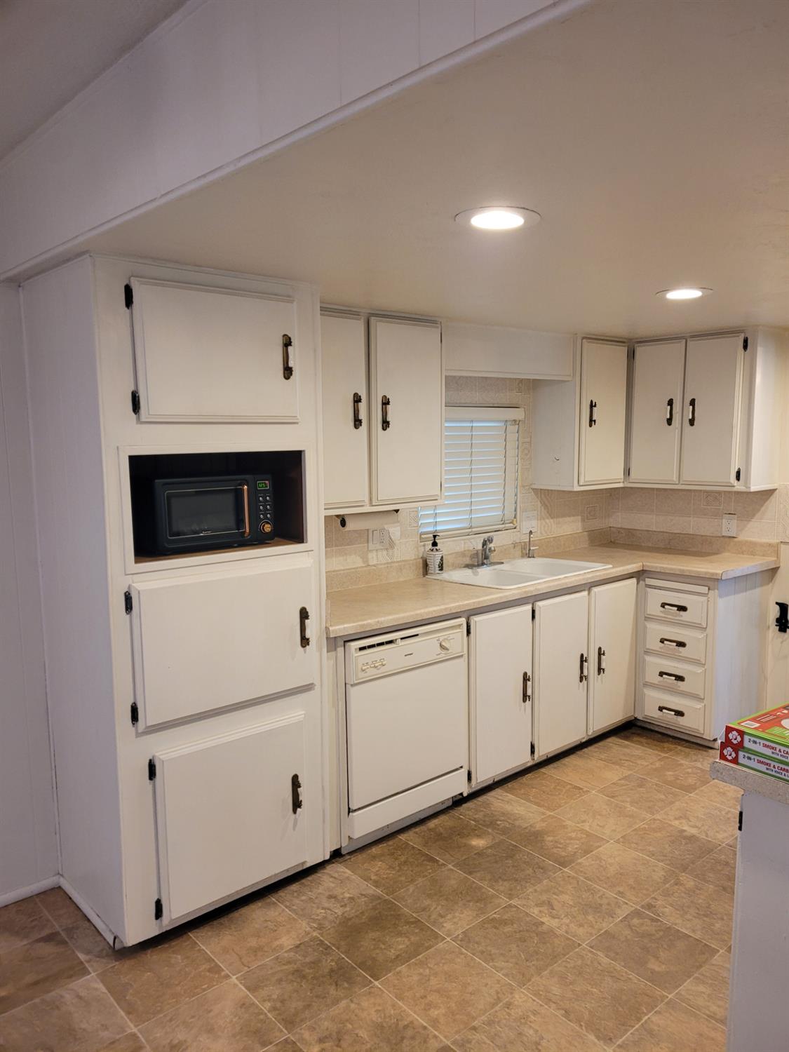 3955 Coffee Road, Unit 53 Modesto, CA 95355 - Photo 14 of 26 a kitchen with white cabinets white stainless steel appliances and sink