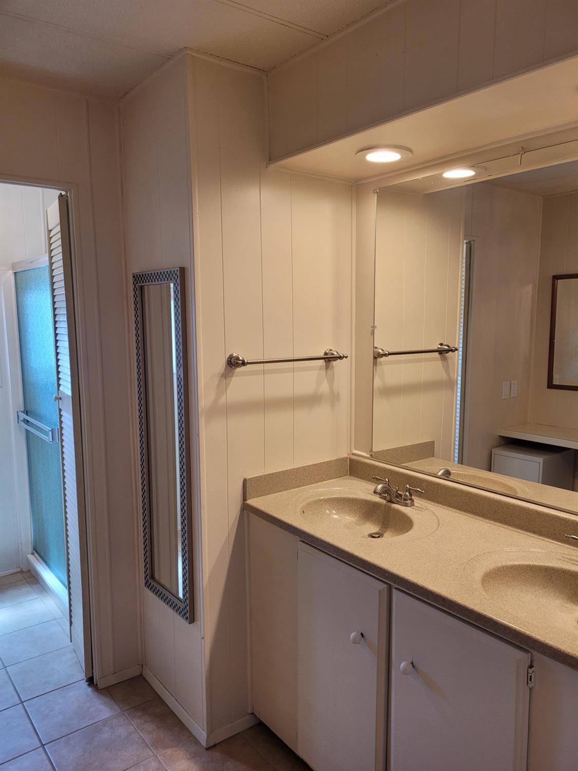 3955 Coffee Road, Unit 53 Modesto, CA 95355 - Photo 18 of 26 a bathroom with a sink and a large mirror