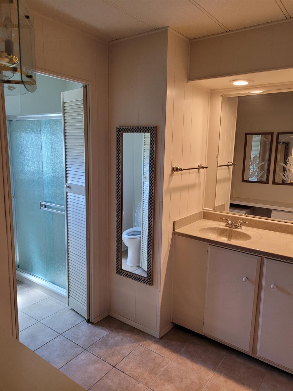 3955 Coffee Road, Unit 53 Modesto, CA 95355 - Photo 19 of 26 a bathroom with a sink and a mirror