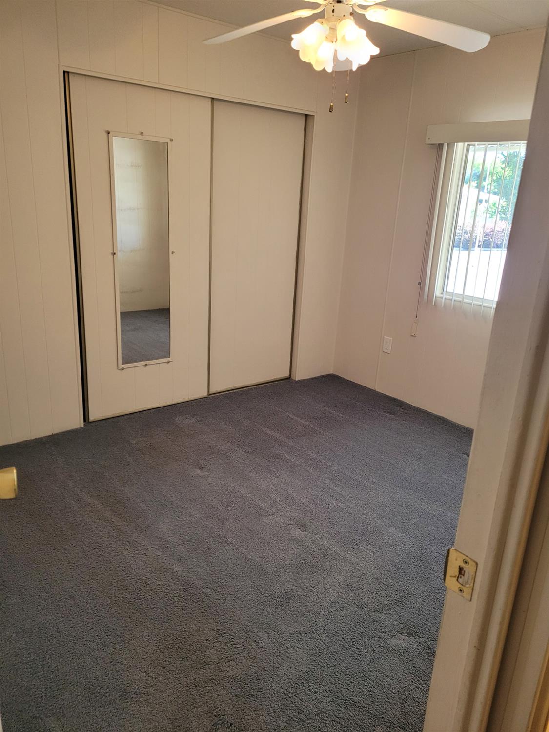 3955 Coffee Road, Unit 53 Modesto, CA 95355 - Photo 22 of 26 an empty room with closet and mirror