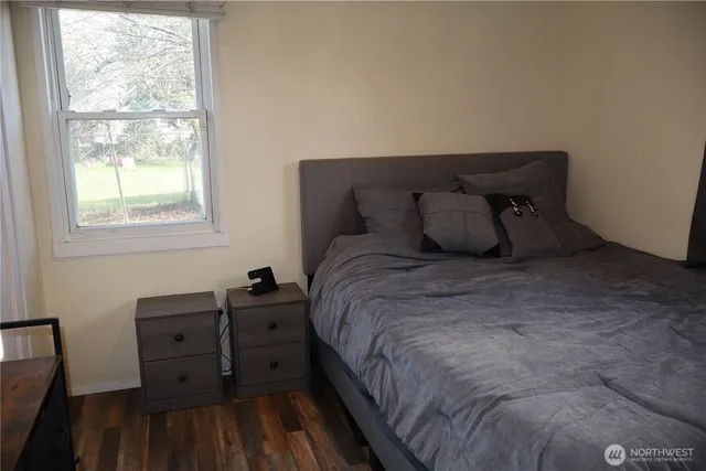 a large bed sitting in a bedroom next to a window