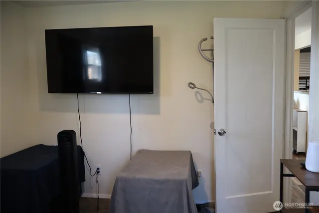 a room with a chair and a flat screen tv