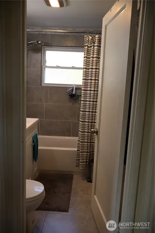 a bathroom with a shower and a toilet