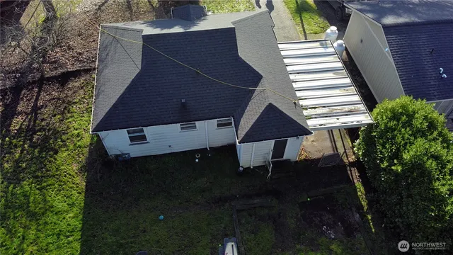 a backyard of a house with table and chairs