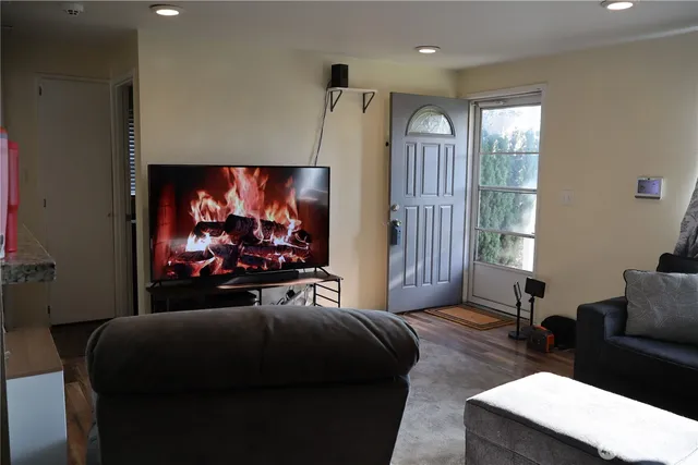 a view of a livingroom with furniture and a flat screen tv