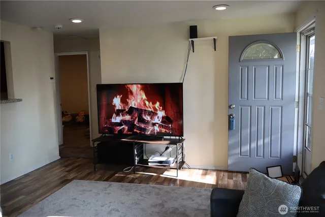 a room with furniture a flat screen tv and a fireplace