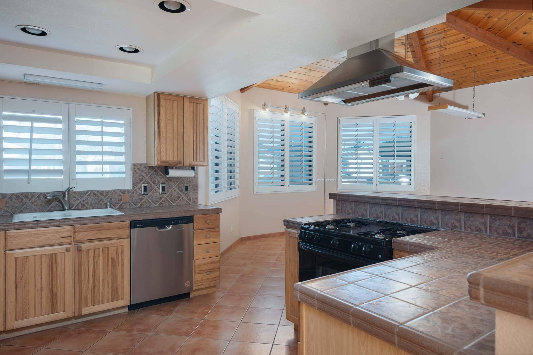 67705 Ovante Road Cathedral City, CA 92234 - Photo 14 of 34 a kitchen with granite countertop a sink and a stove