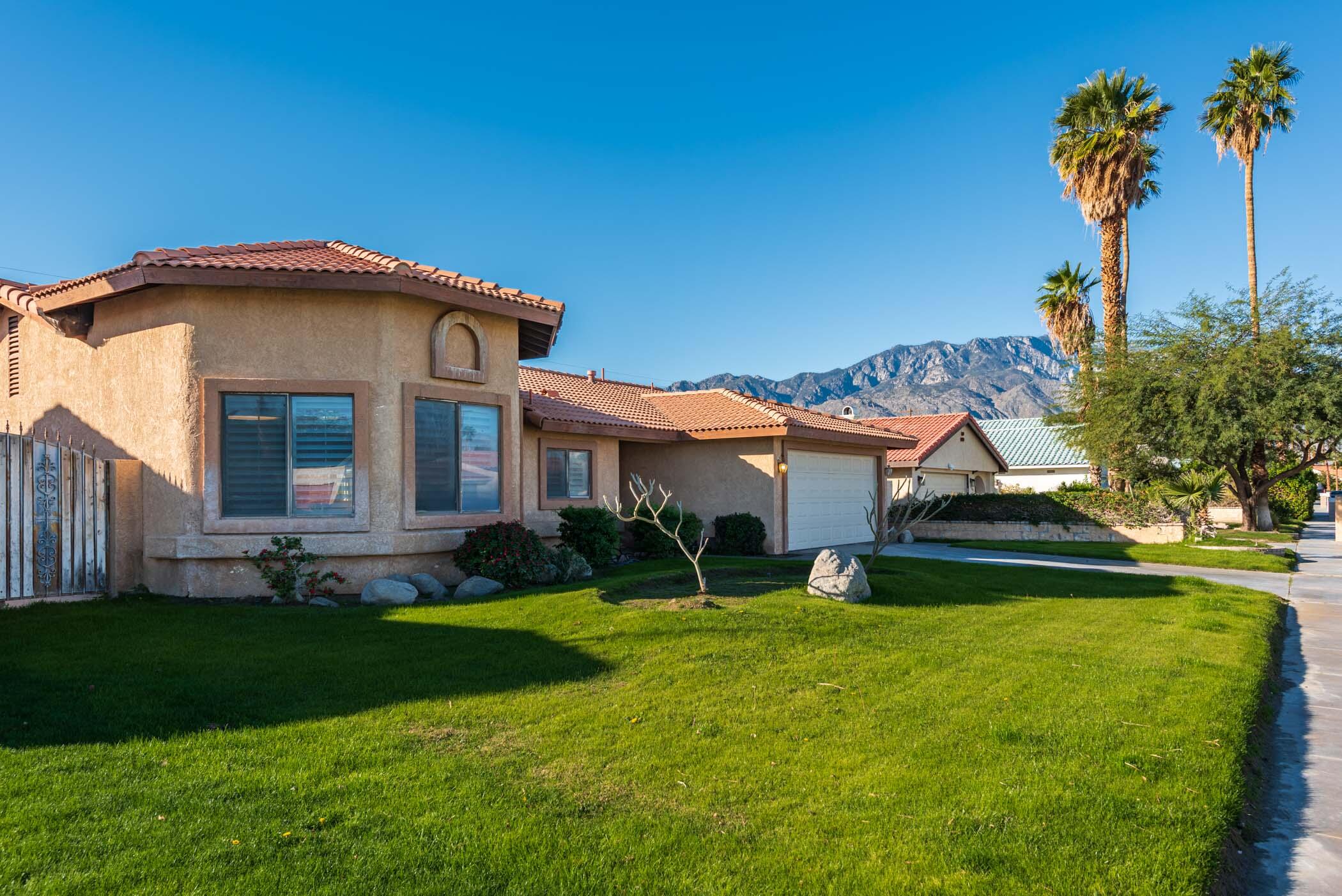 67705 Ovante Road Cathedral City, CA 92234 - Photo 2 of 34 a front view of a house with a yard
