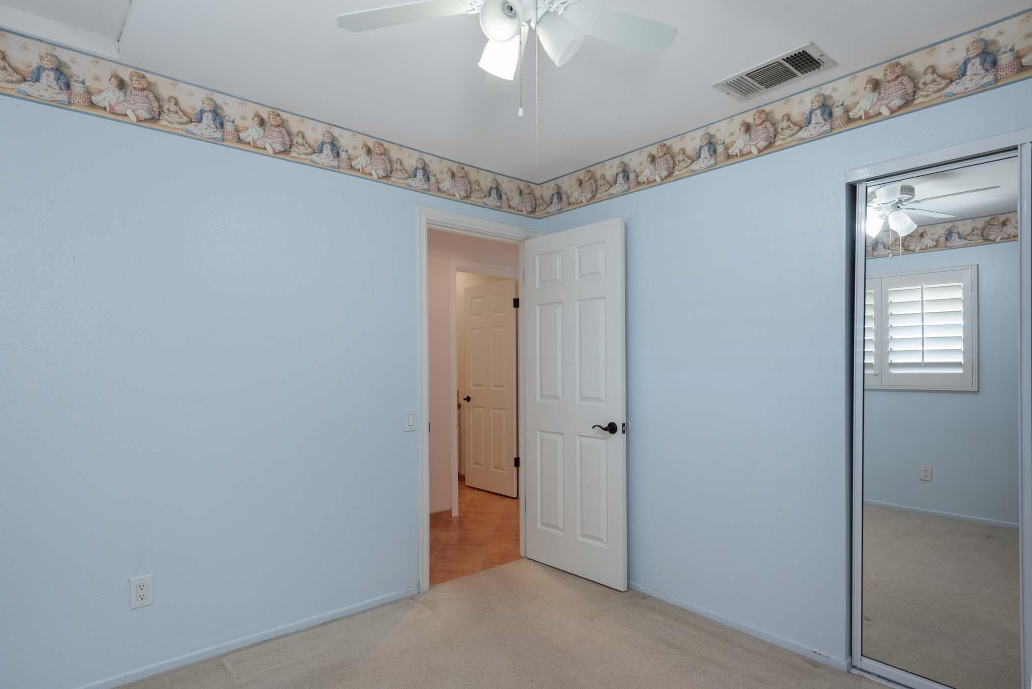 67705 Ovante Road Cathedral City, CA 92234 - Photo 25 of 34 a view of a hallway with a chandelier fan and windows