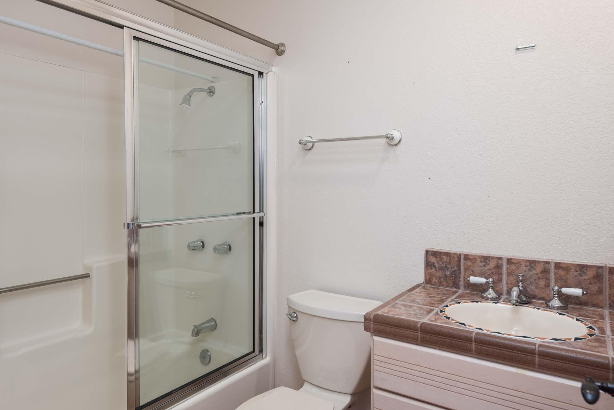 67705 Ovante Road Cathedral City, CA 92234 - Photo 28 of 34 a bathroom with a granite countertop sink toilet and shower