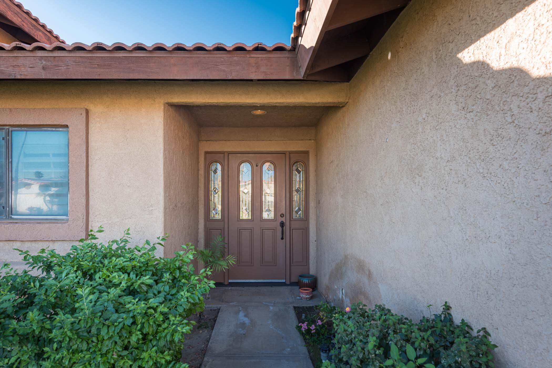 67705 Ovante Road Cathedral City, CA 92234 - Photo 3 of 34 a front view of a house with a yard