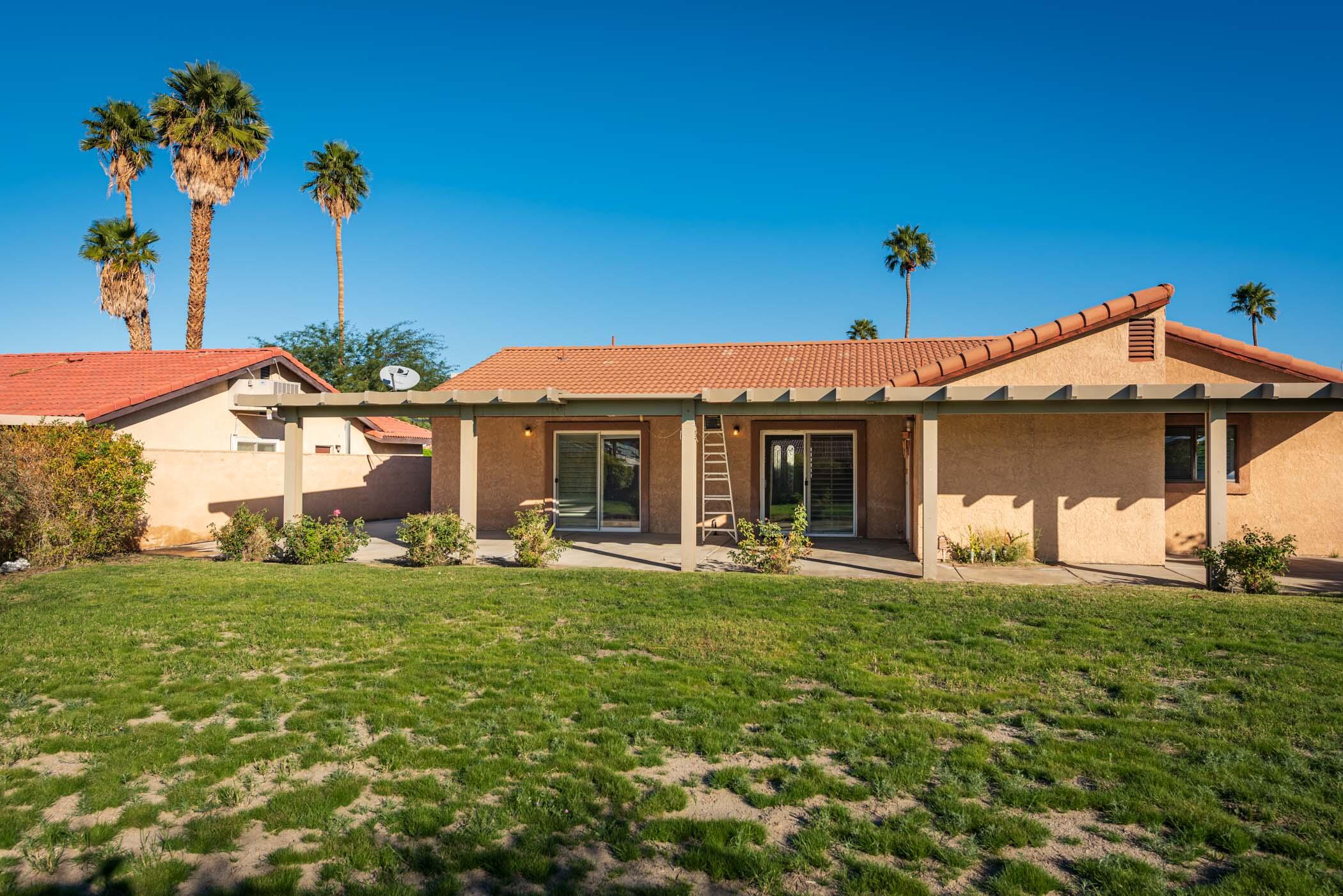 67705 Ovante Road Cathedral City, CA 92234 - Photo 33 of 34 a front view of a house with a garden and yard