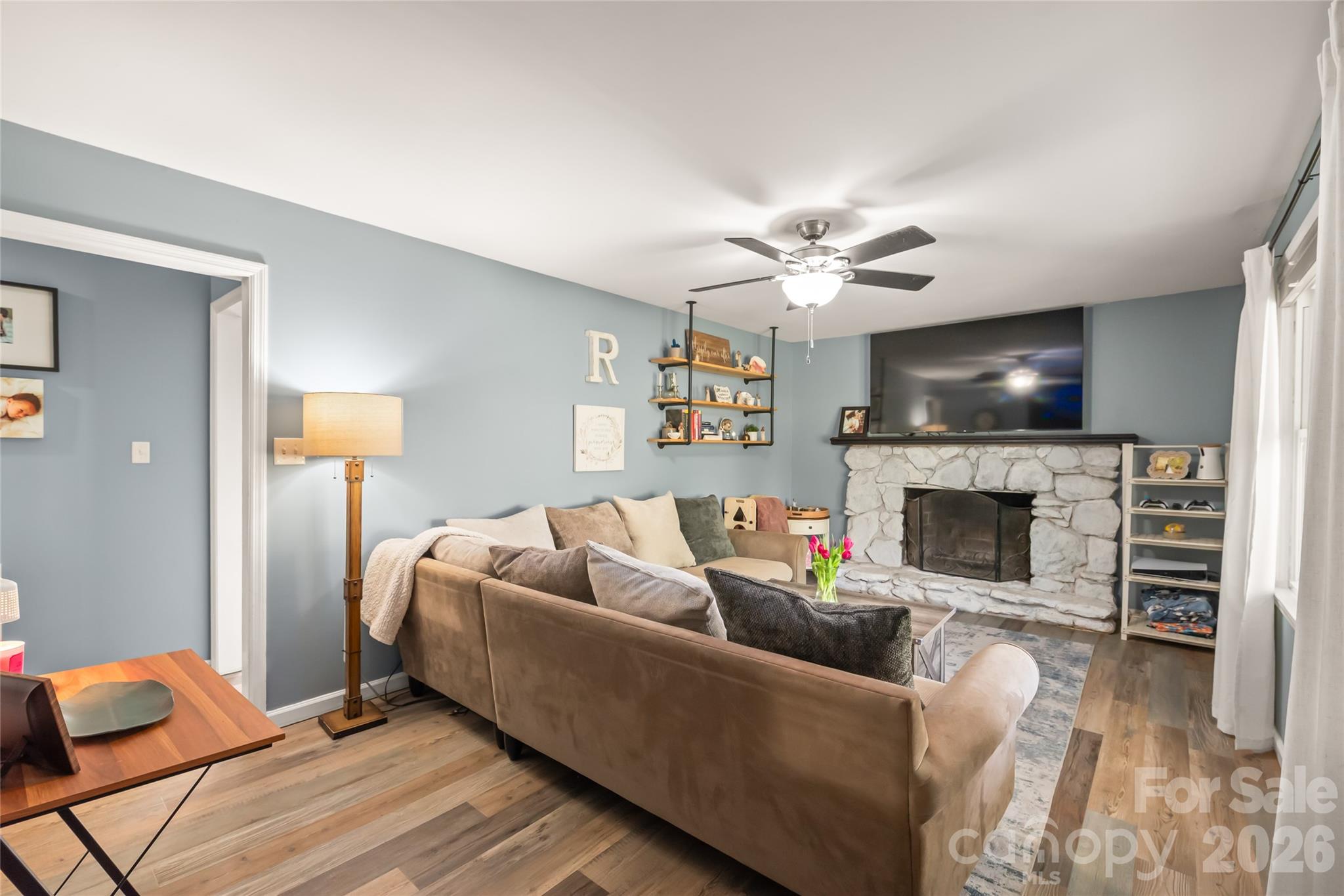 104 Pine Tree Drive Fort Mill, SC 29715 - Photo 4 of 35 a living room with furniture a fireplace and a flat screen tv