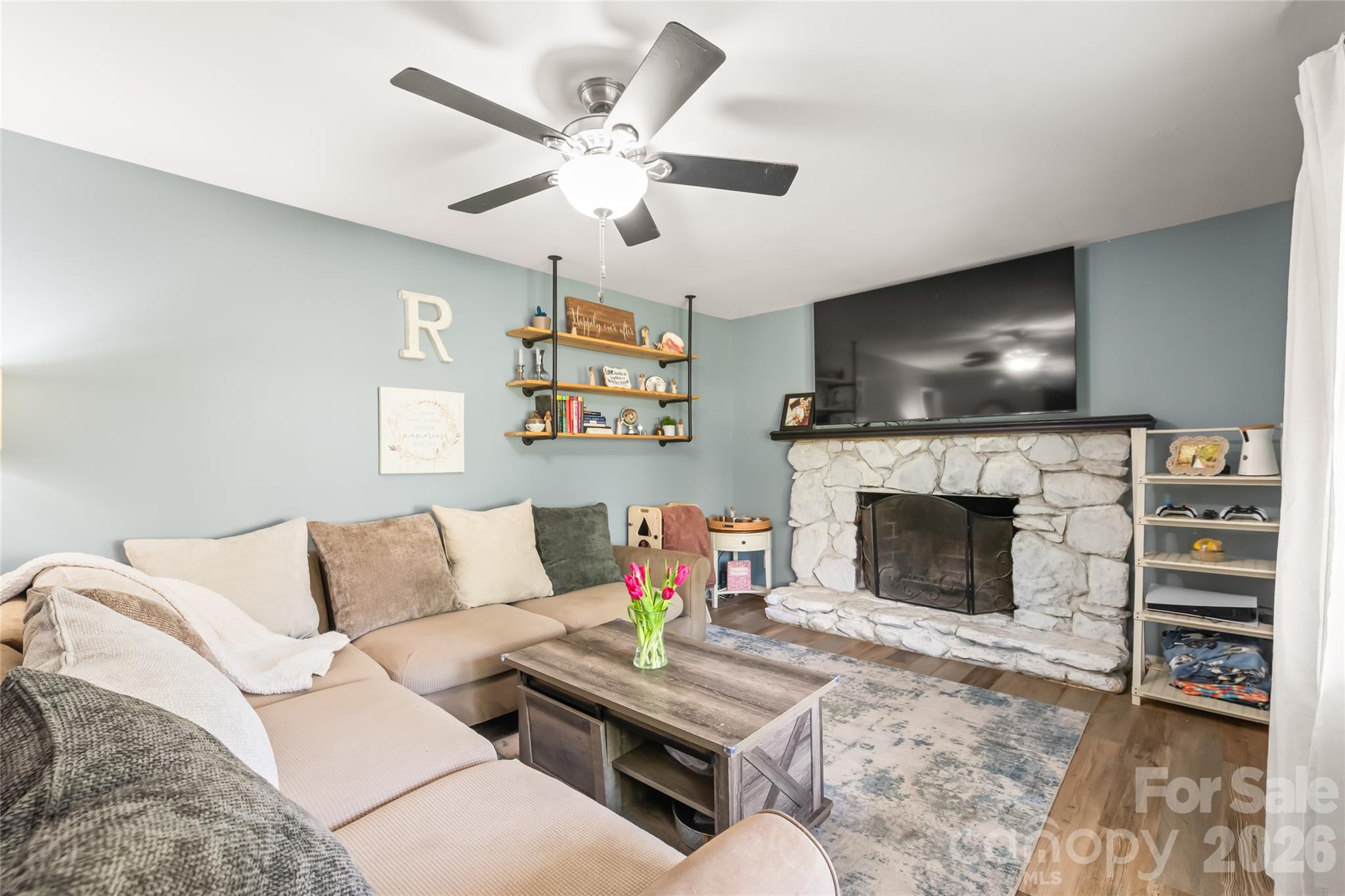 104 Pine Tree Drive Fort Mill, SC 29715 - Photo 5 of 35 a living room with furniture a flat screen tv and a fireplace