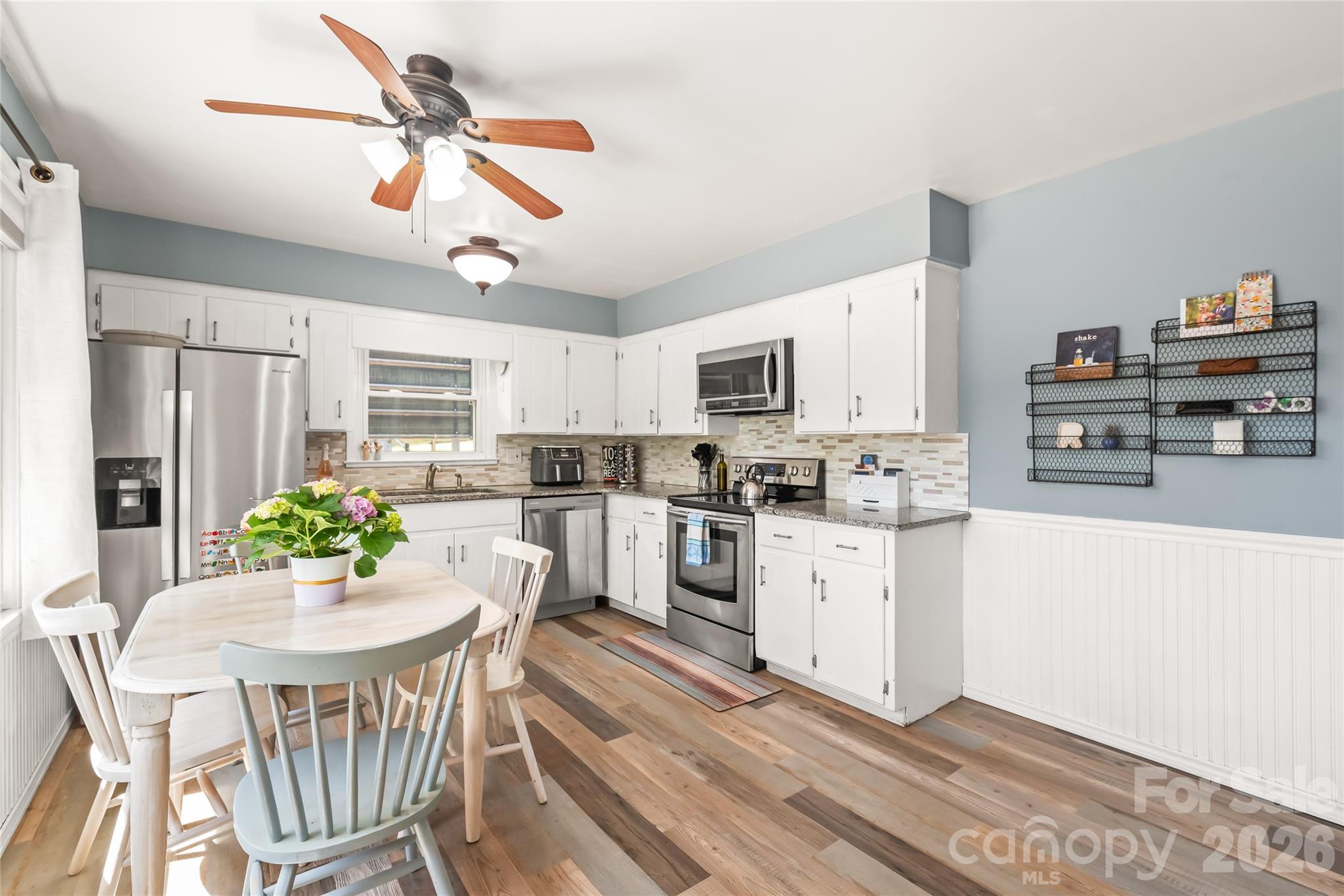 104 Pine Tree Drive Fort Mill, SC 29715 - Photo 9 of 35 a kitchen with refrigerator cabinets dining table and chairs