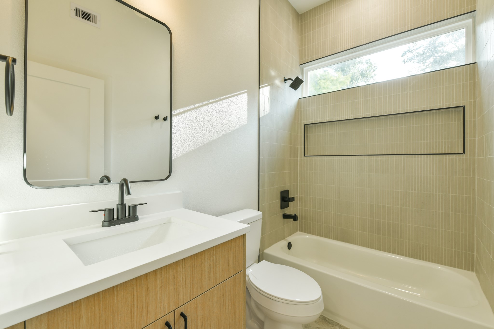 164 Wallace Street Houston, TX 77022 - Photo 17 of 19 a bathroom with a sink a toilet and shower