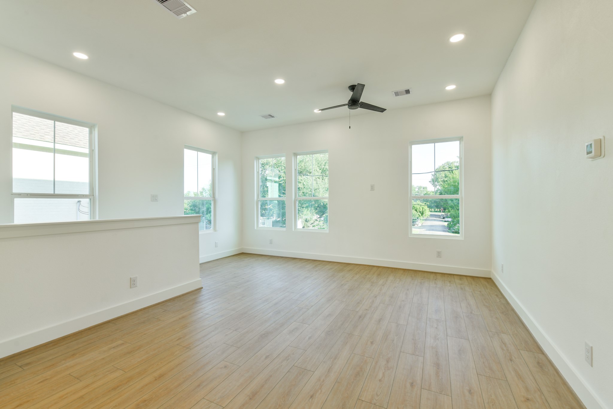 164 Wallace Street Houston, TX 77022 - Photo 19 of 19 an empty room with wooden floor and windows
