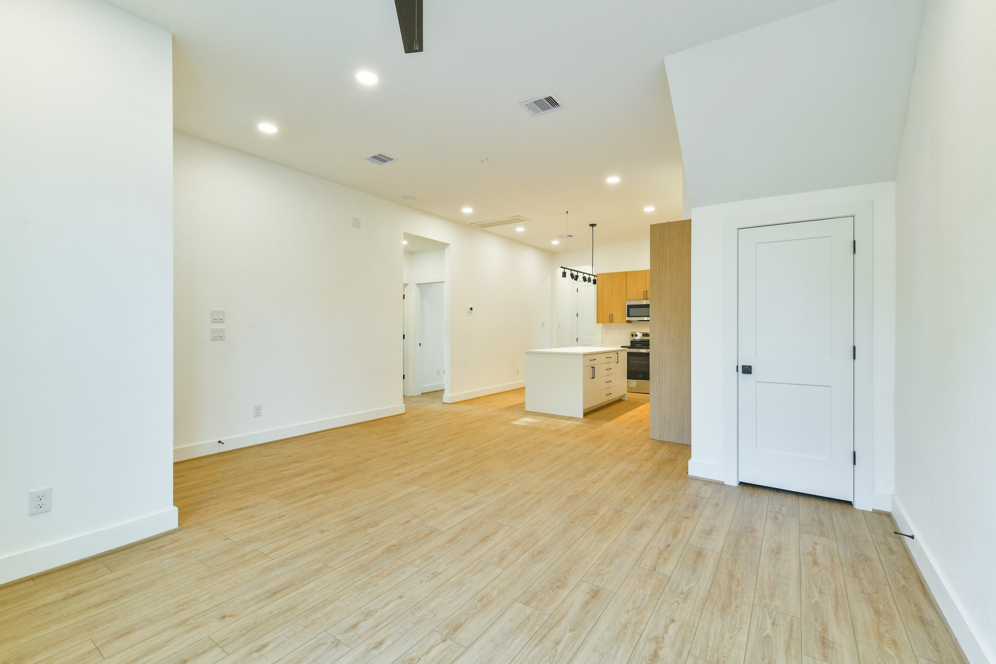 164 Wallace Street Houston, TX 77022 - Photo 4 of 19 a view of an empty room with wooden floor and a window