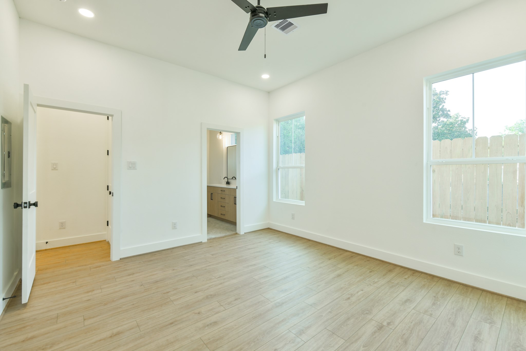 164 Wallace Street Houston, TX 77022 - Photo 5 of 19 an empty room with wooden floor and windows
