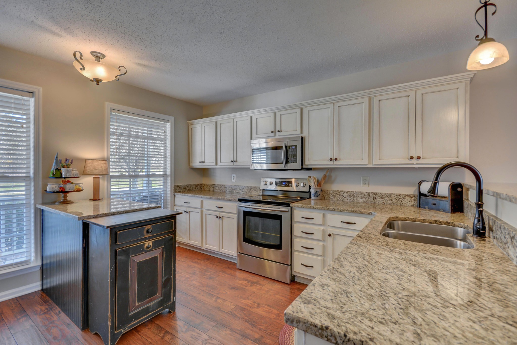 2545 Plainview Pvt Ln Spring Hill Spring Hill, TN 37174 - Photo 12 of 34 a kitchen with granite countertop a stove top oven a sink dishwasher and a stove with wooden floor