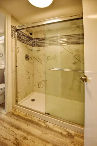 a bathroom with a shower and a sink