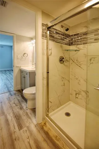 a bathroom with a granite countertop sink a toilet and a mirror