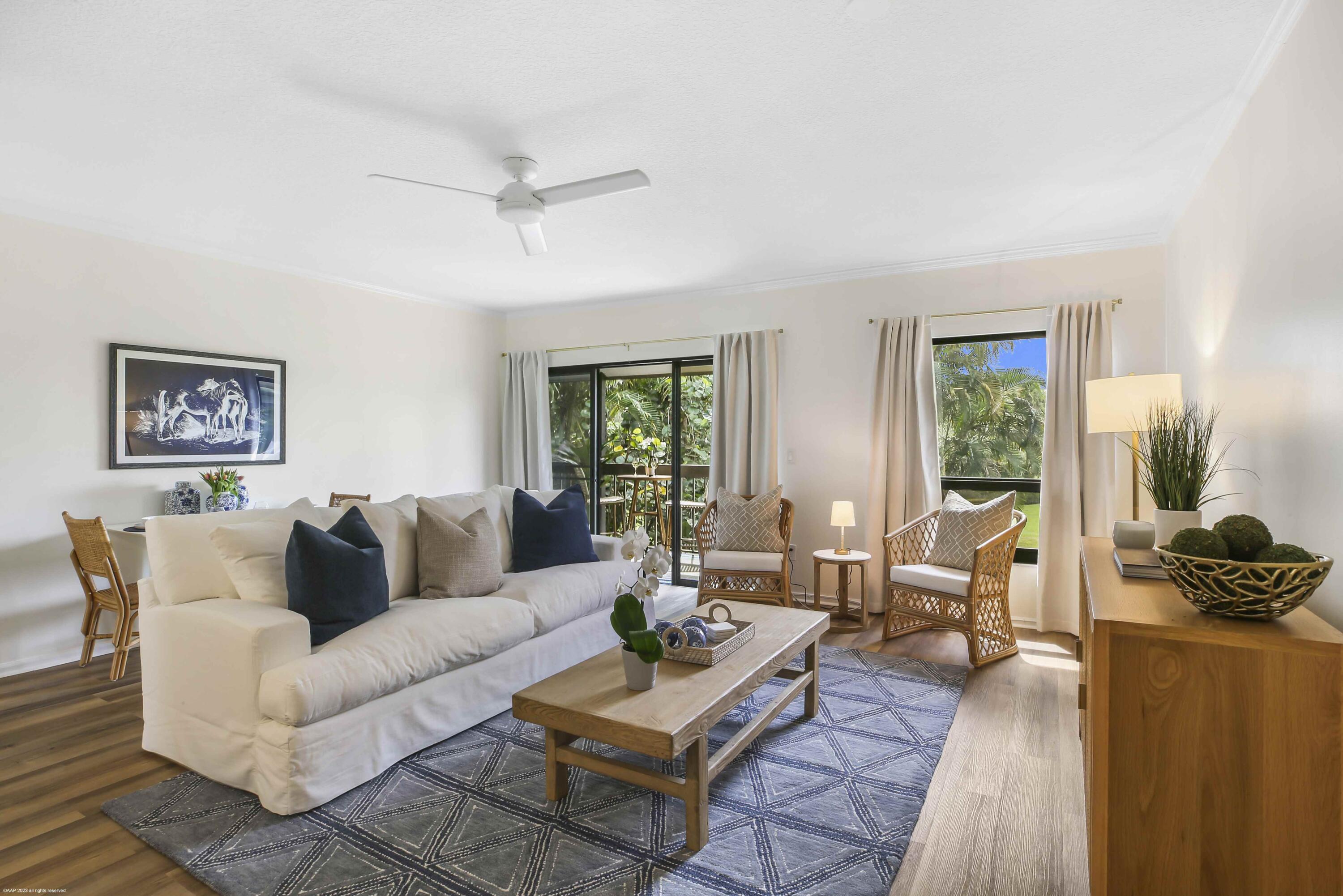 13334 Polo Club Road, Unit 346 Wellington, FL 33414 - Photo 1 of 19 a living room with furniture and a large window