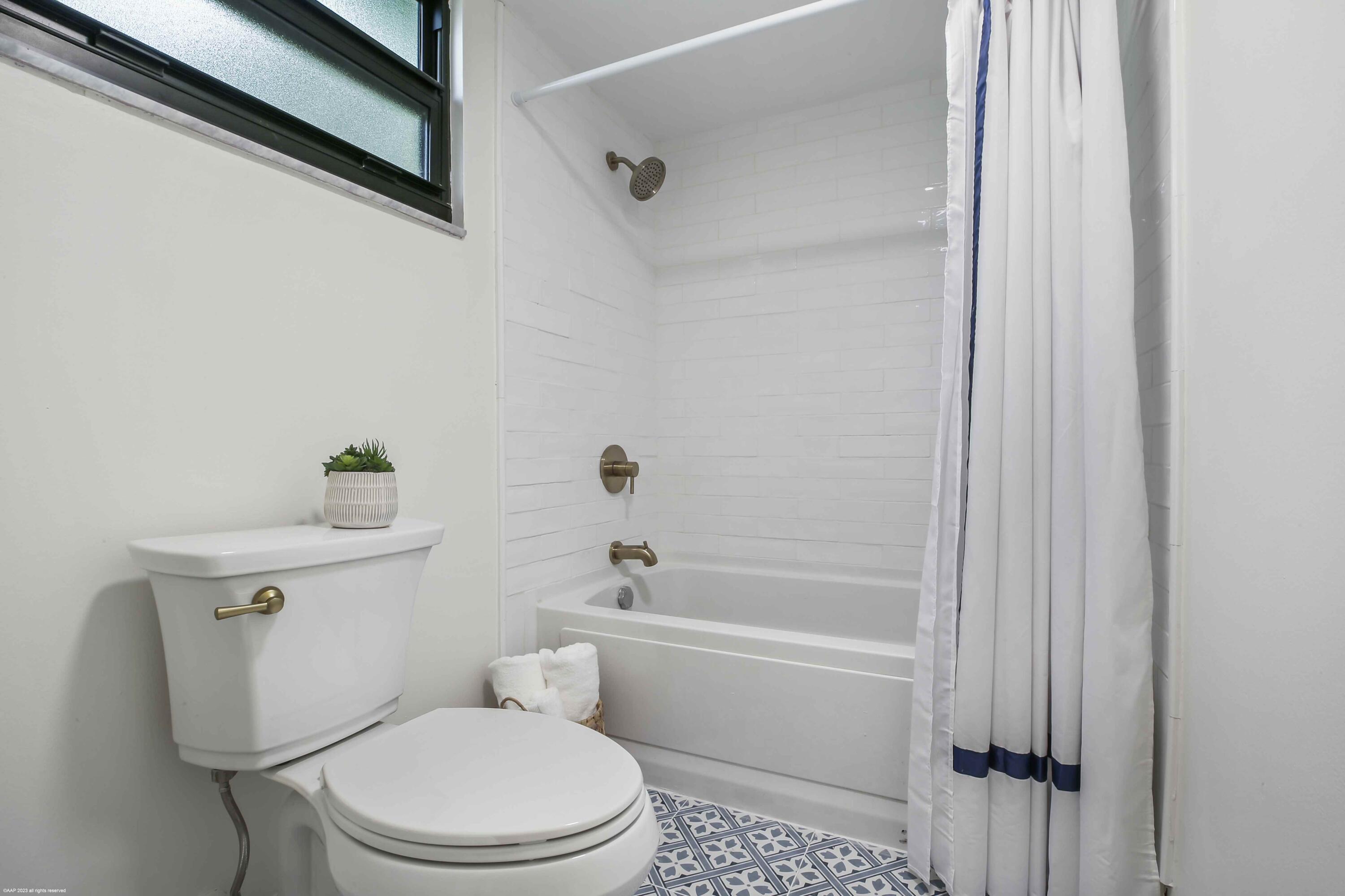 13334 Polo Club Road, Unit 346 Wellington, FL 33414 - Photo 14 of 19 a white toilet sitting next to a bath tub